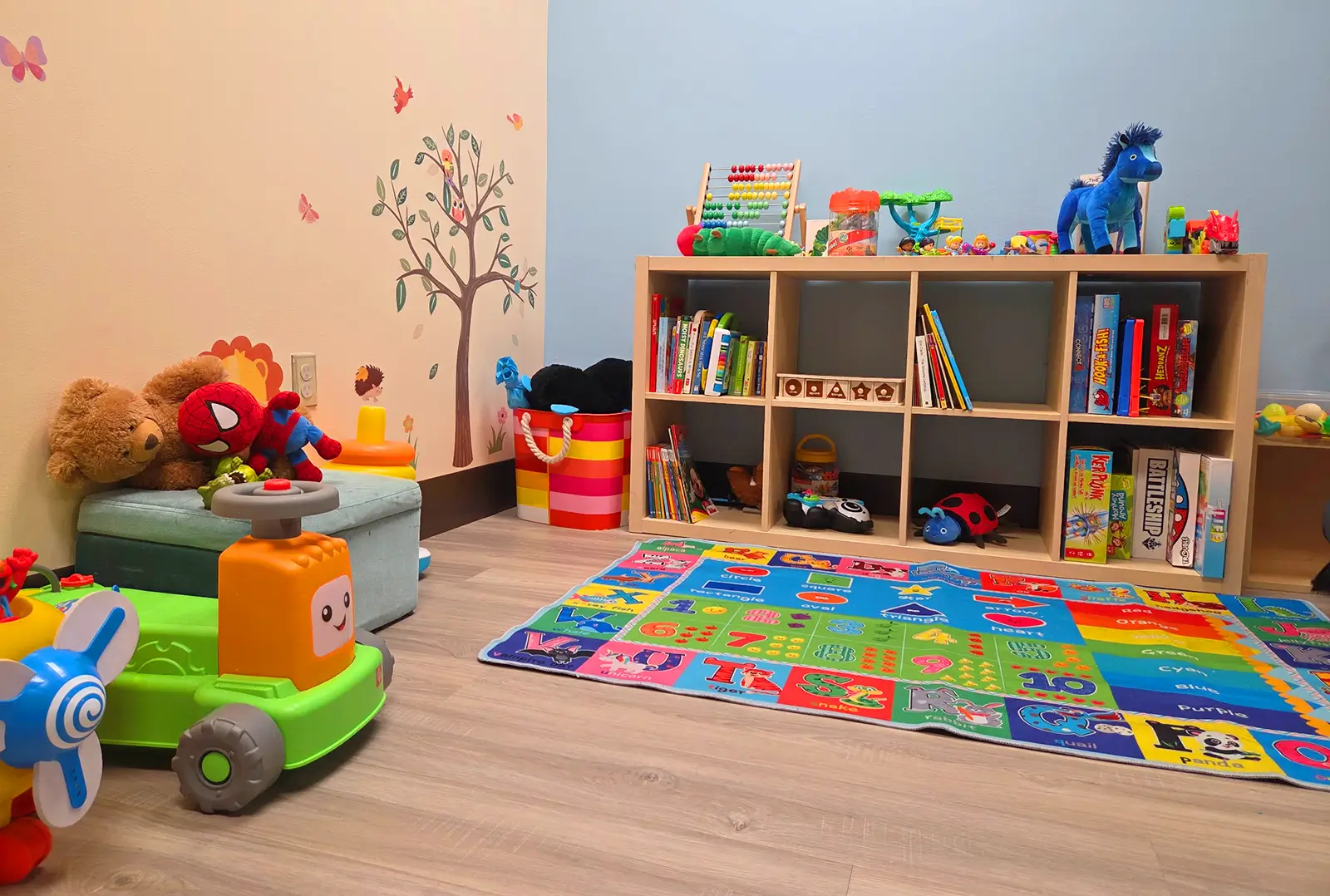 Colorful pediatric ABA therapy playroom at CAI ABA in Hurst TX with educational toys books sensory rug and learning materials for children with autism